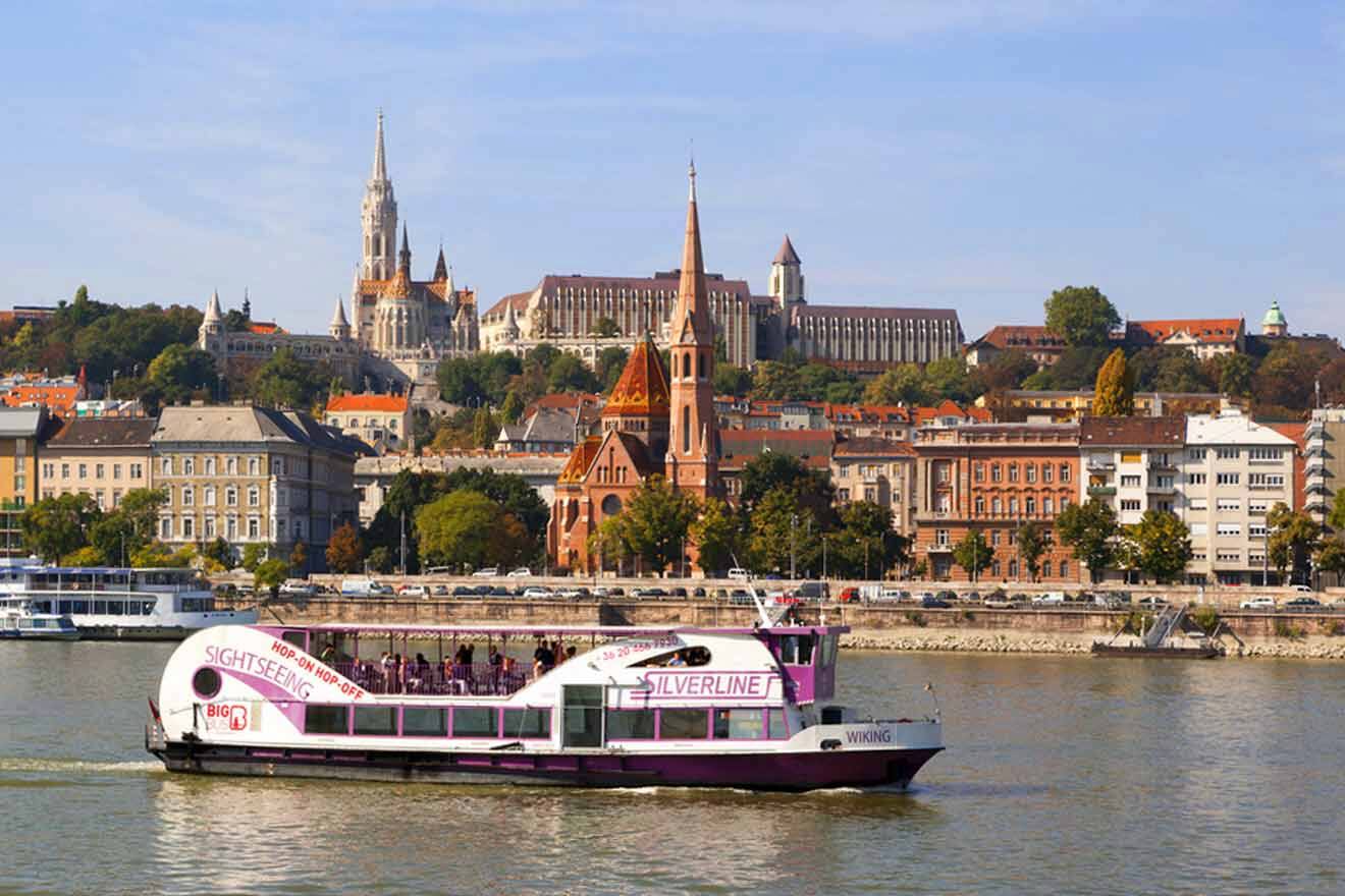 boat on a river with the city in the background