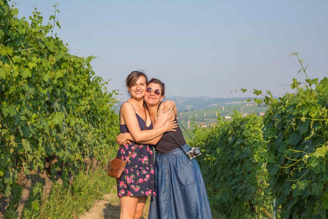 Two women hugging in a vineyard.