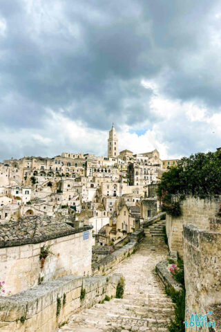 A city with stone buildings and a cloudy sky.