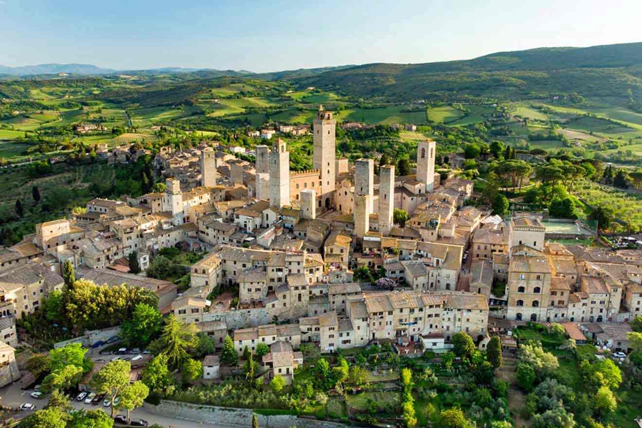 aerial view over a city surrounded by greenery