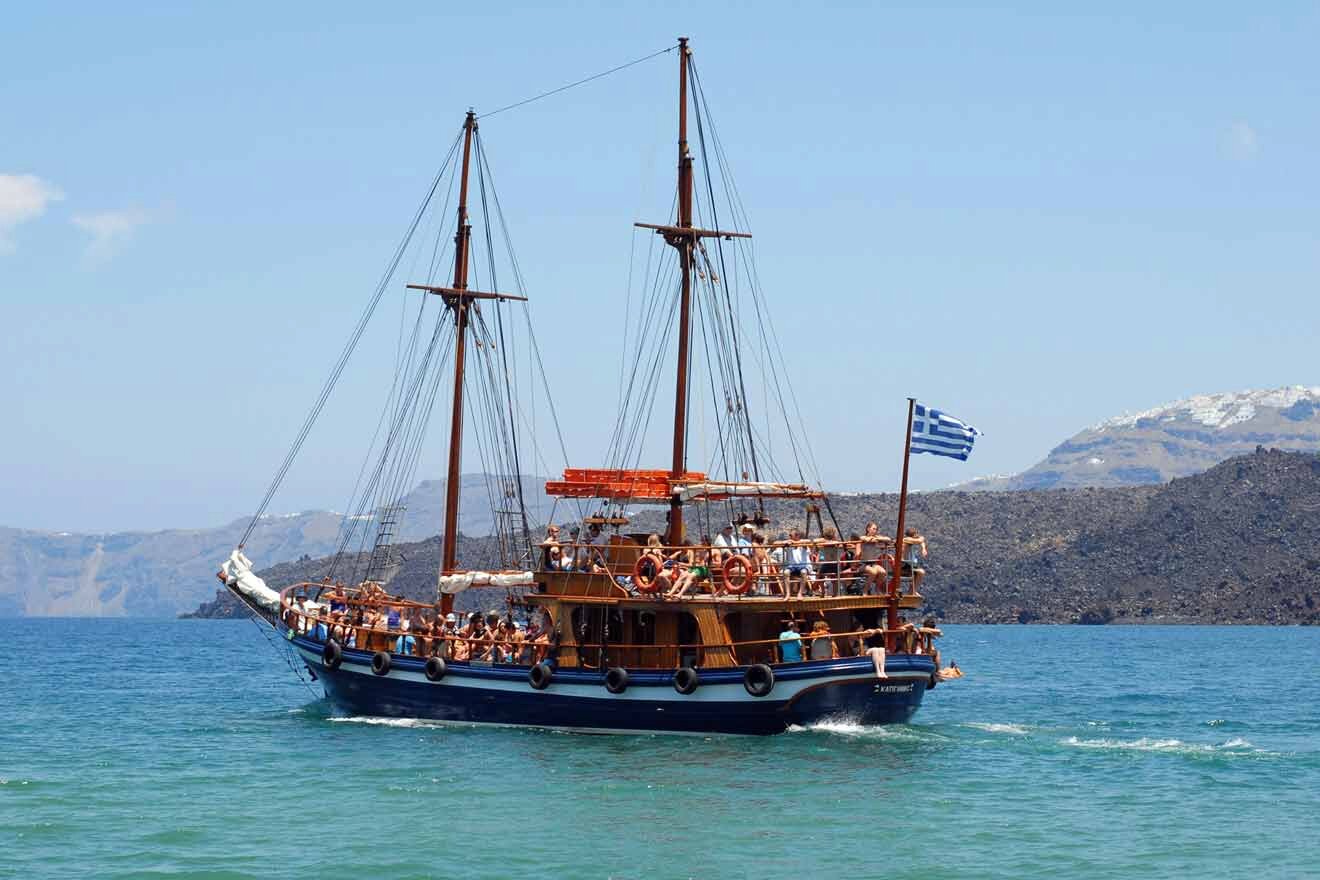 A large boat with people on it in the water.