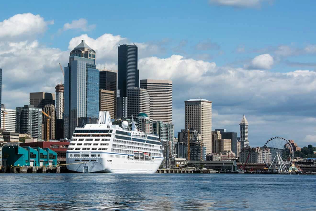 a large white boat in front of a city