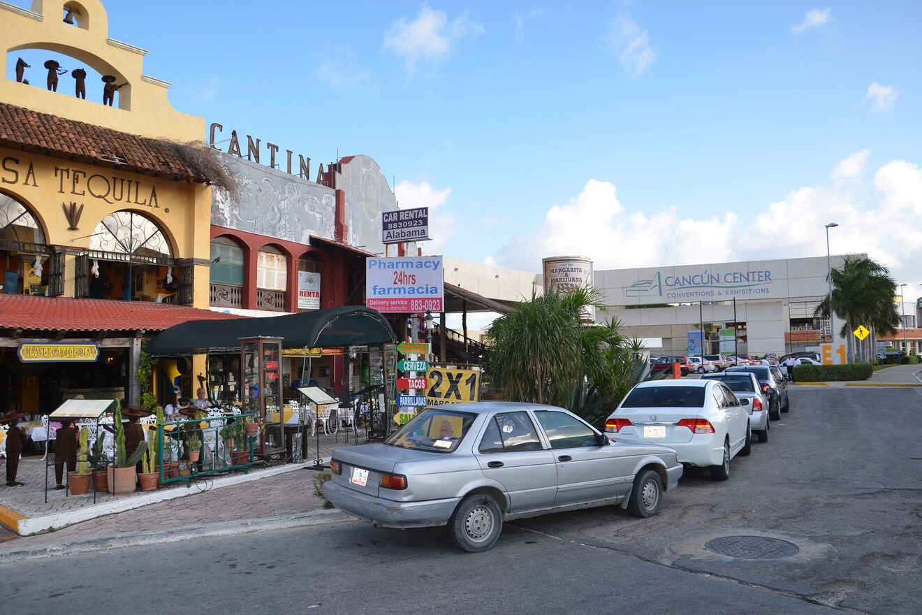 A street with cars parked in front of a building.