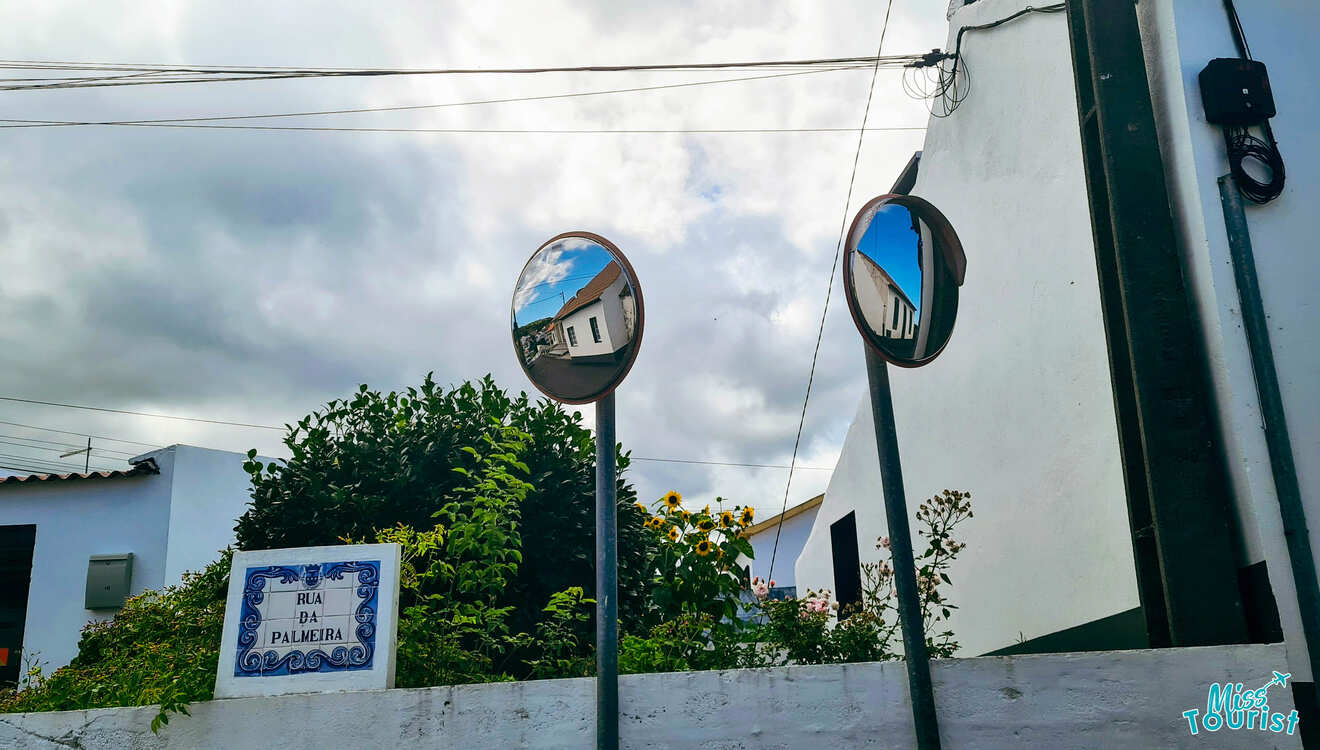 Two street mirrors near the building.