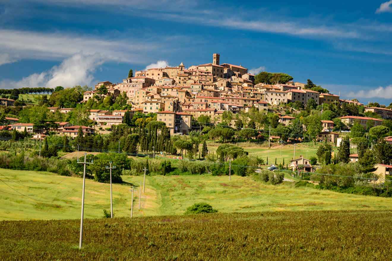 a village on top of a hill surrounded by trees