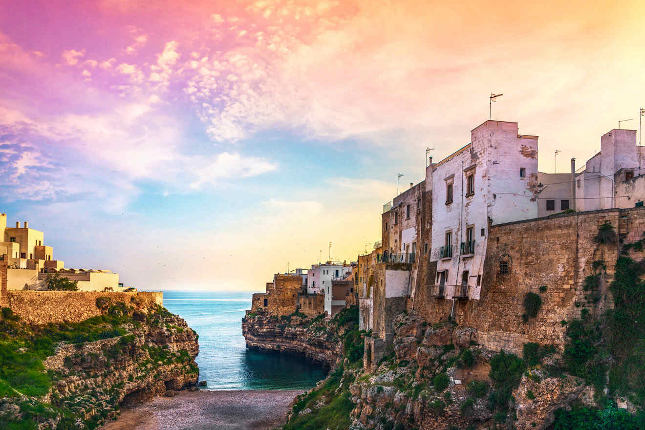 A view of a cliff overlooking the ocean with various buildings on the edge of the cliff