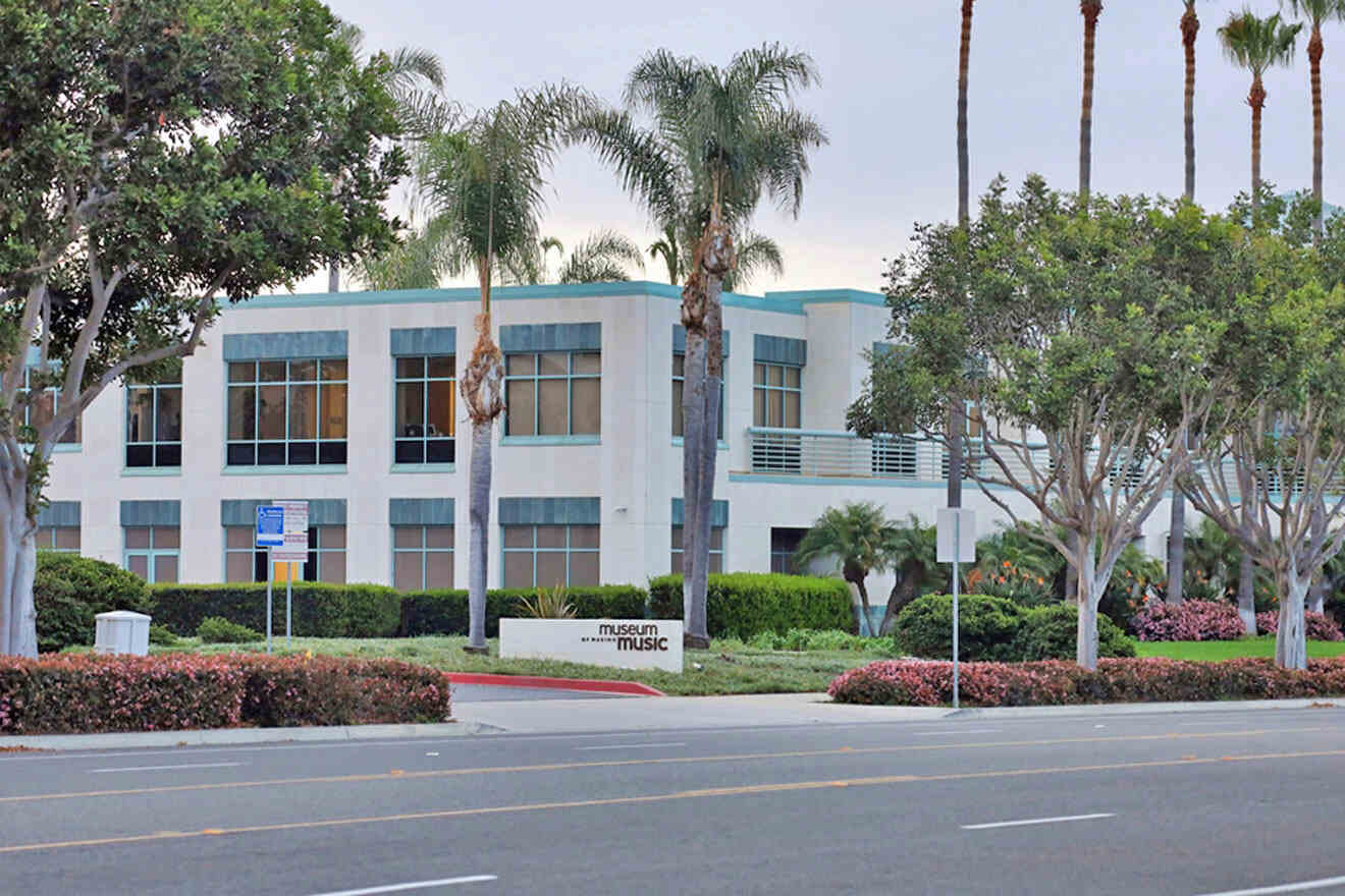 A building with palm trees in front of it.