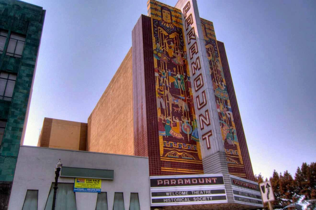 A large building with a theater in front of it.