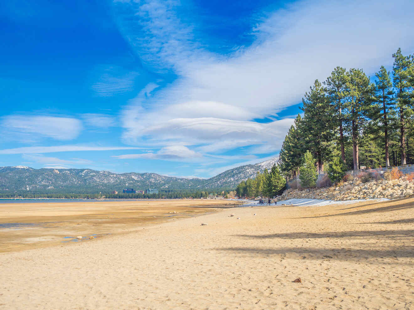 a sandy beach along a lake