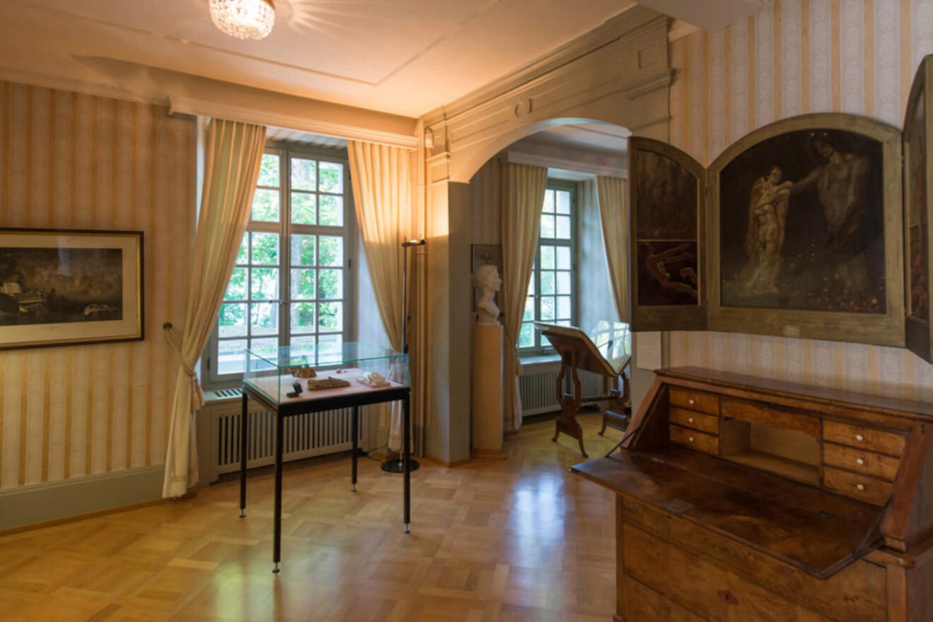 A wooden floor and some museum staff in the room