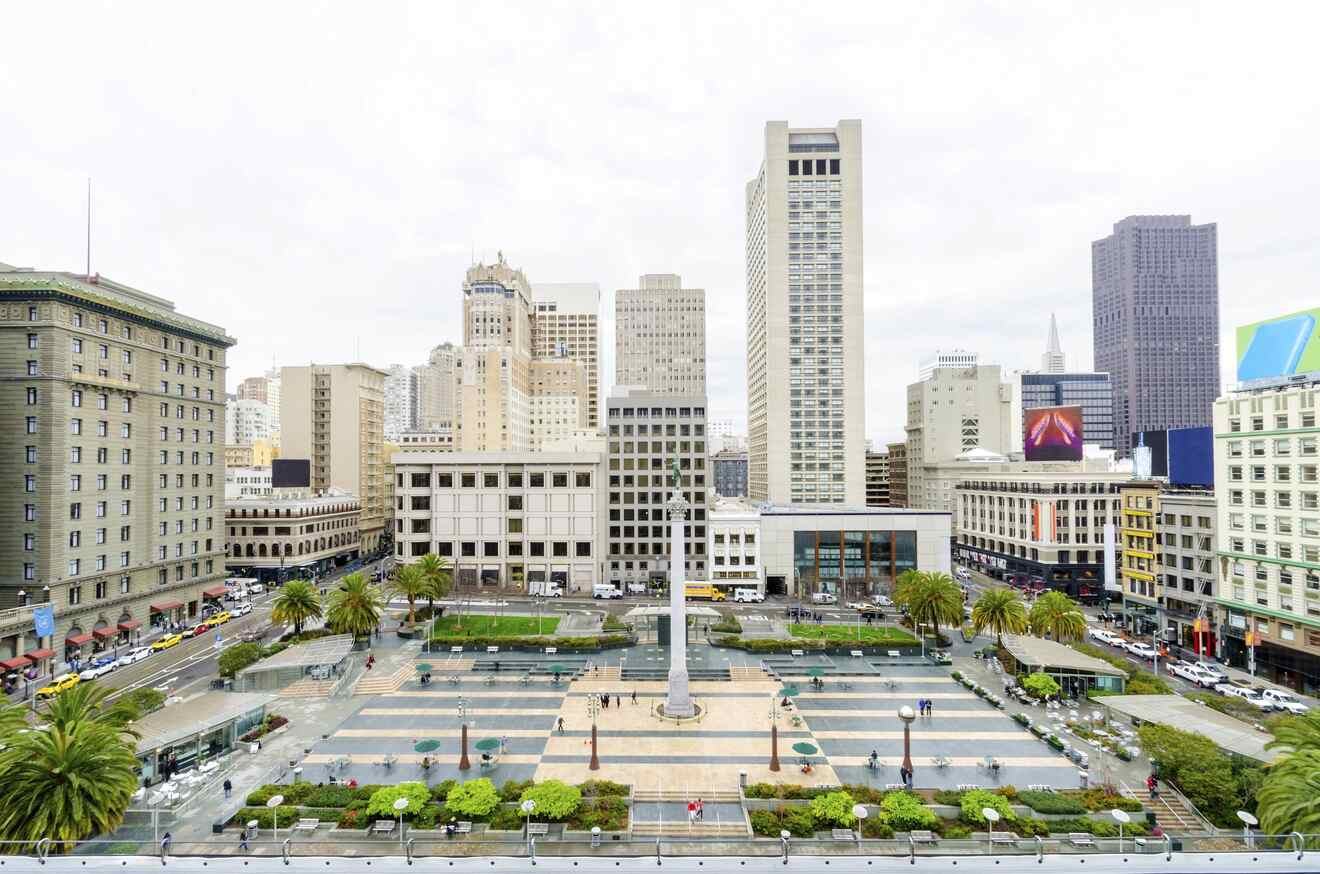 aerial view of a square with a statue surrounded by buildings