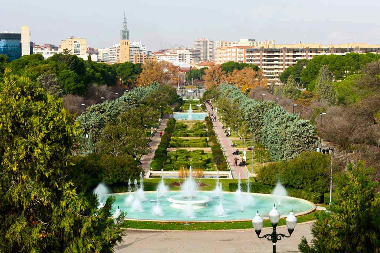 a view of a park with a fountain in the middle