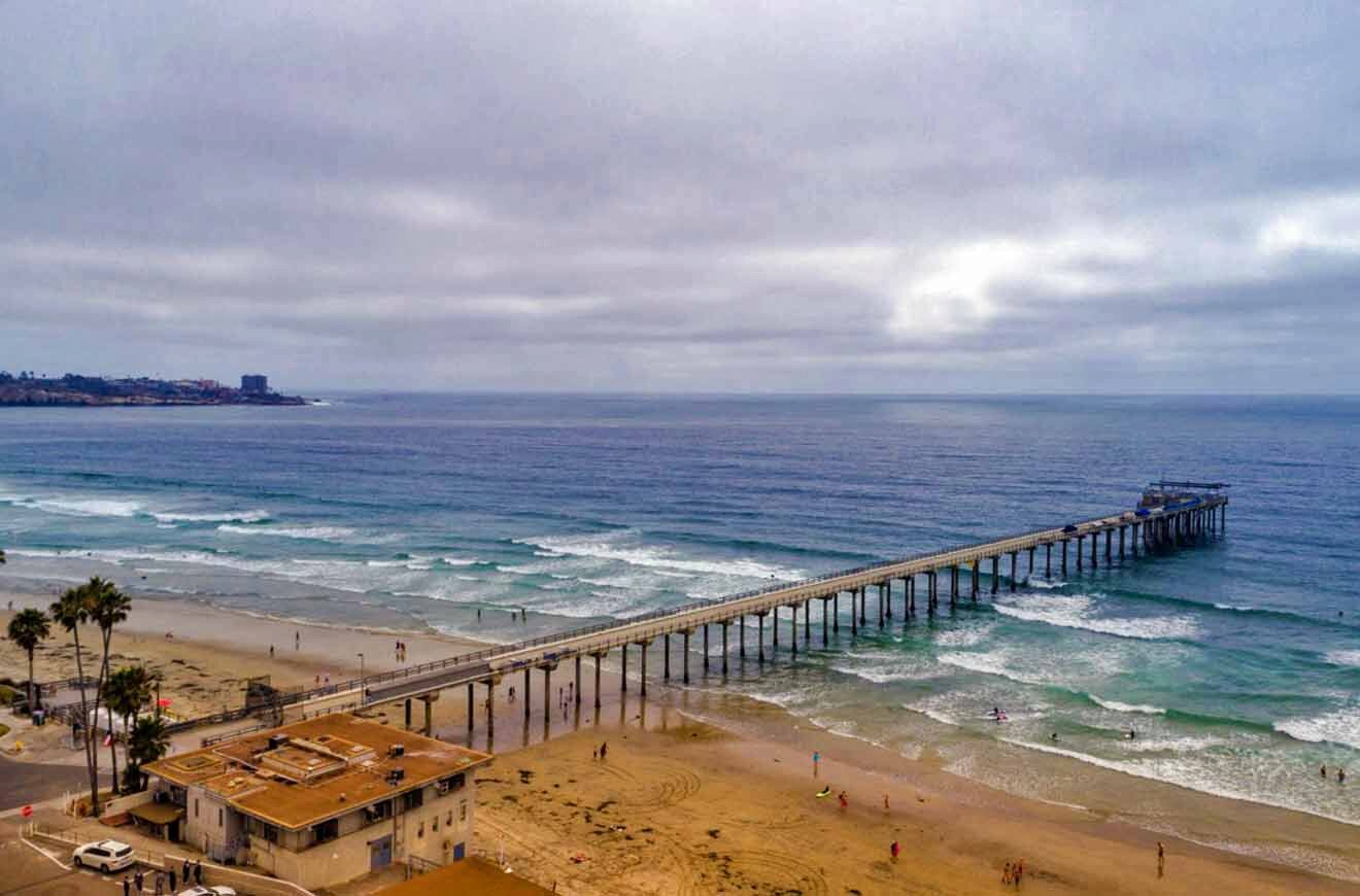 An aerial view of a beach with a pier.