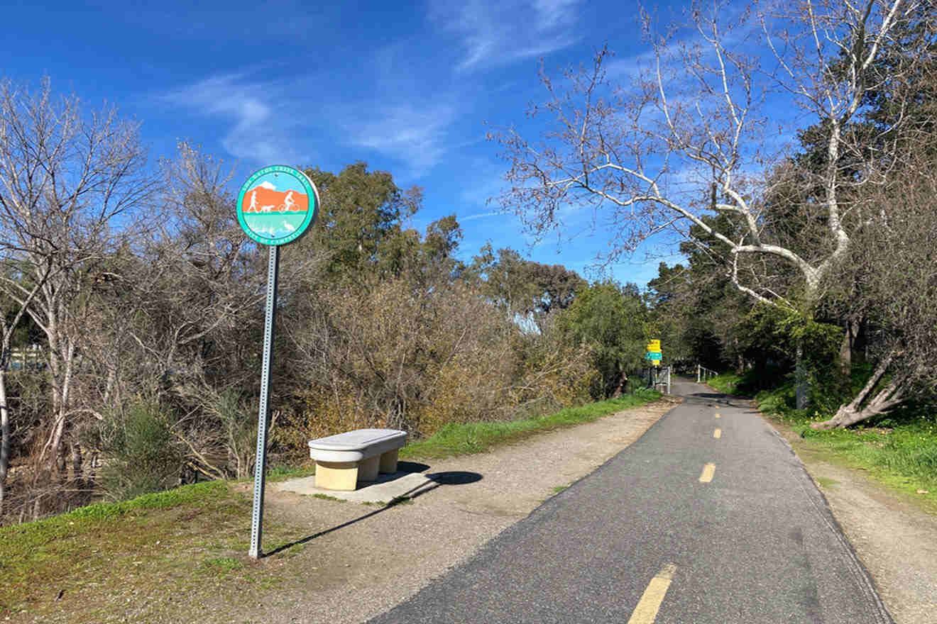 A bike lane with a sign on it next to a trees