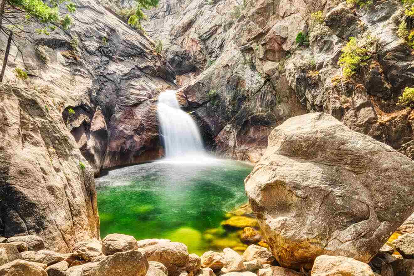 A waterfall surrounded by rocks and water.