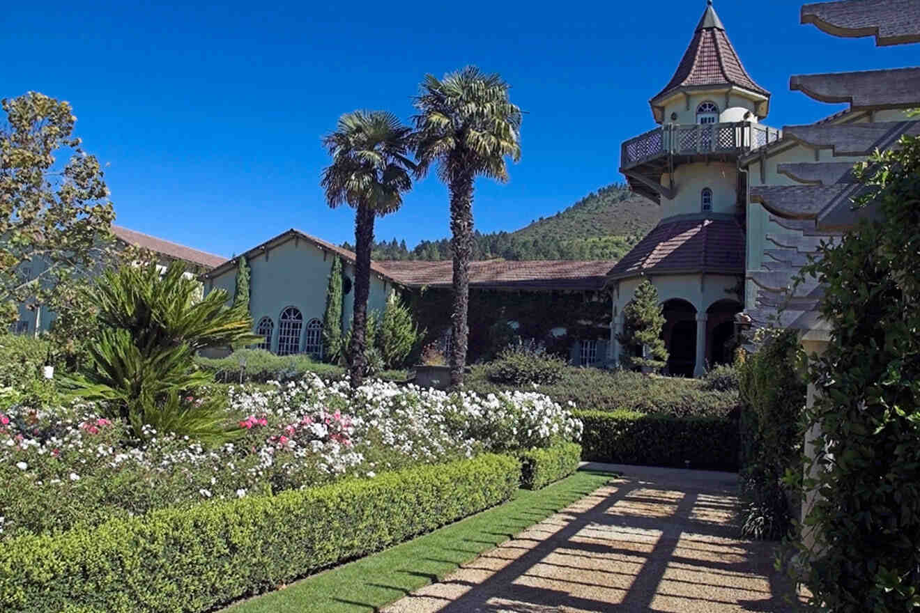 A large mansion with a garden in front of it.