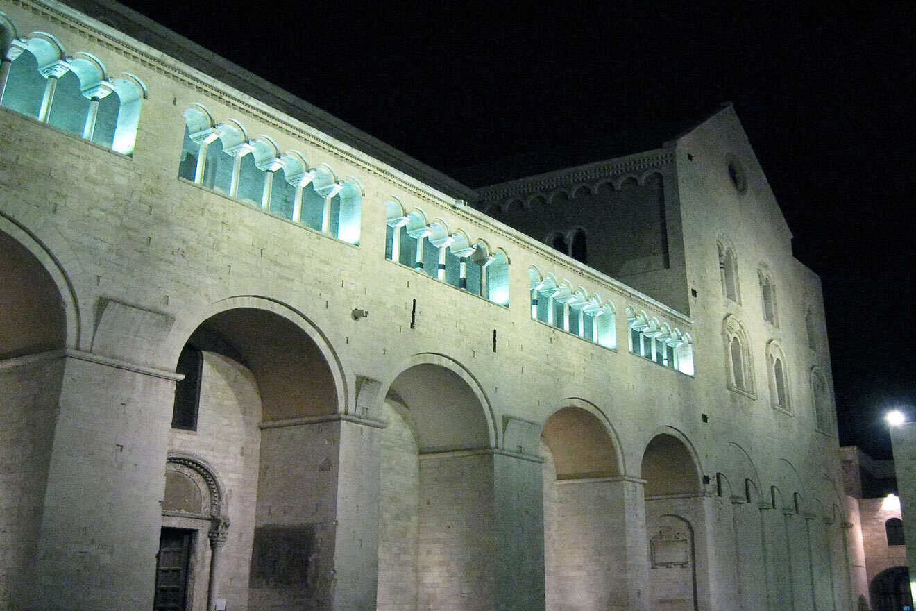 A large stone church with arches at night