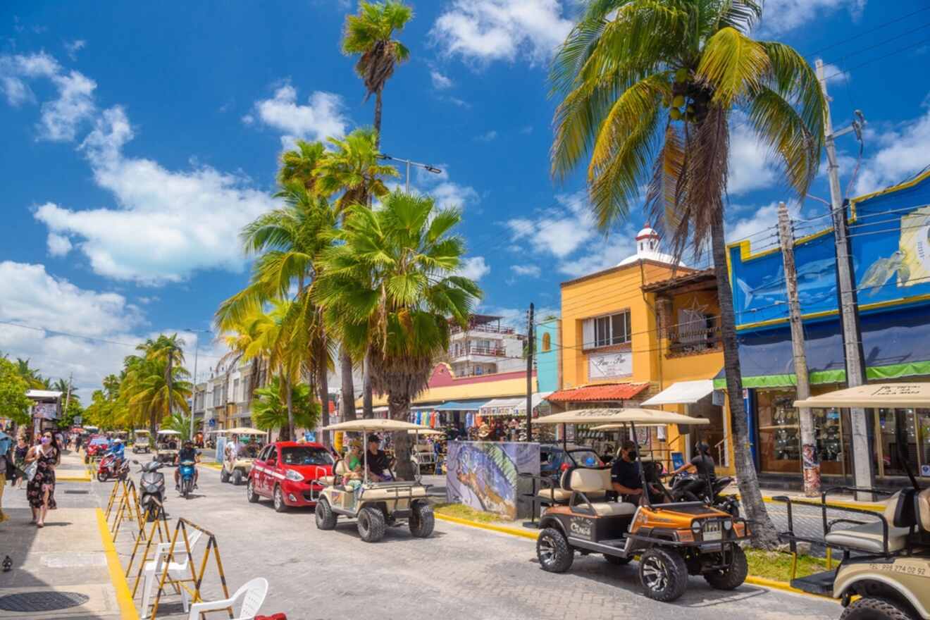 A street lined with golf carts and palm trees.