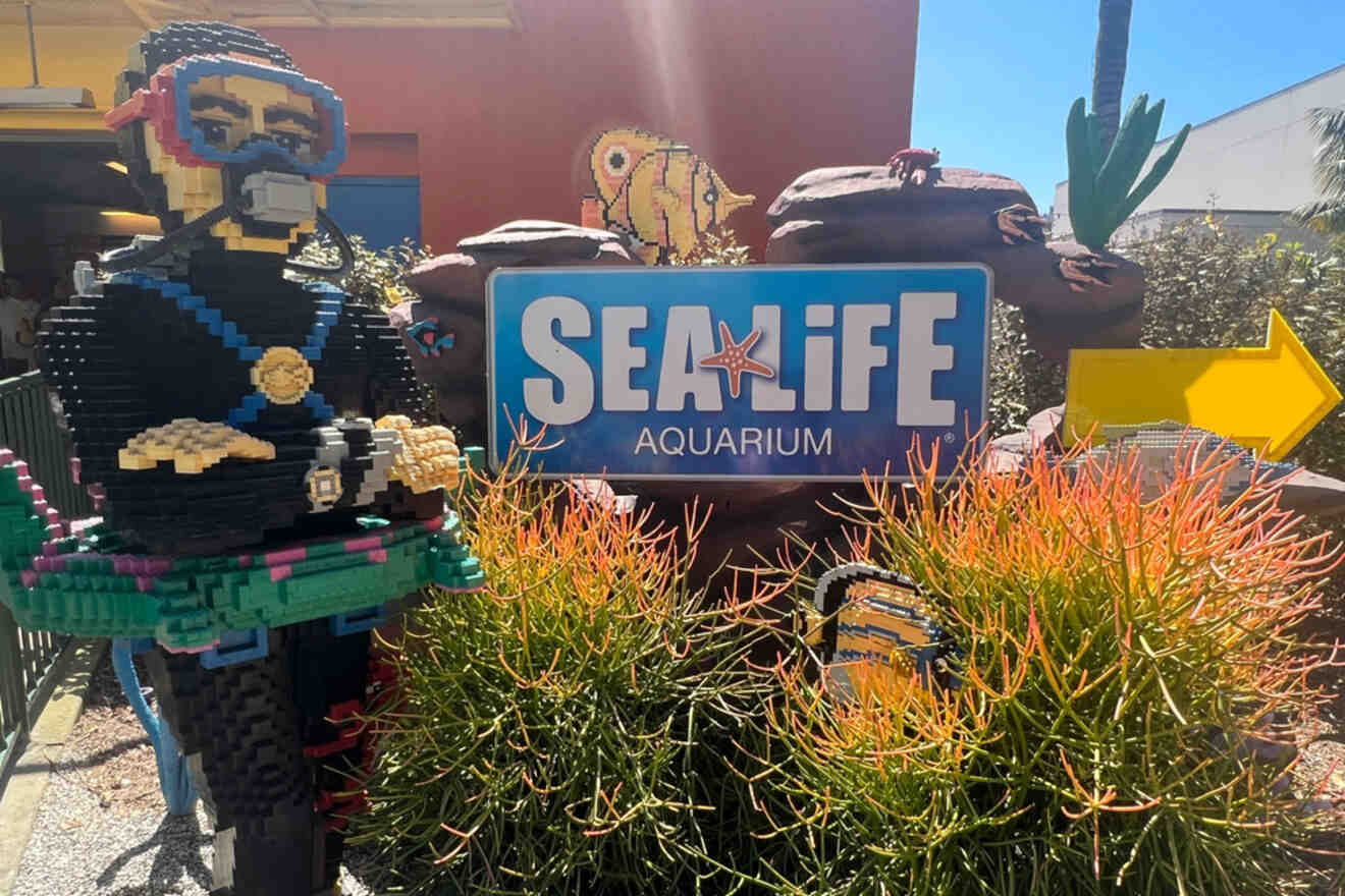 A lego scuba diver in front of a sign for sealife aquarium.
