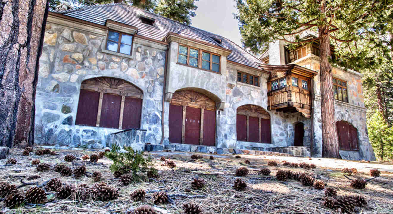 a stone building among pine trees