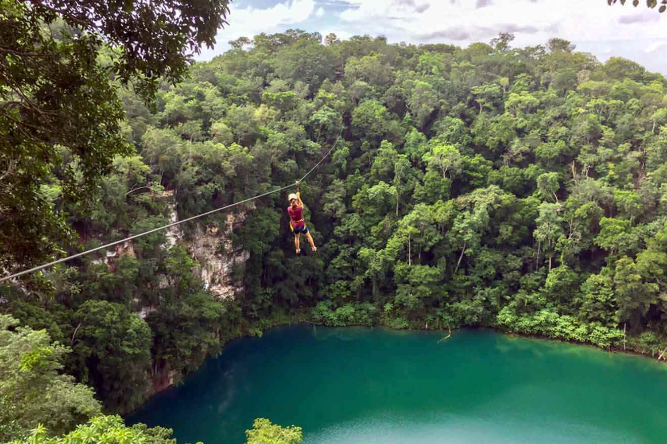 A person on a zip line over a cenote
