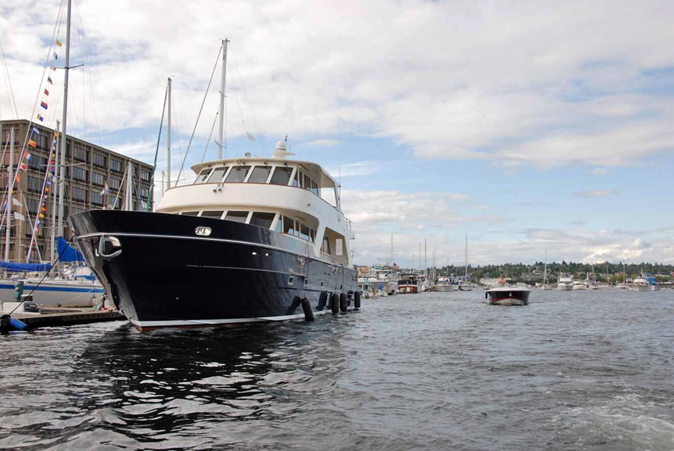 a black and white boat is docked in the water