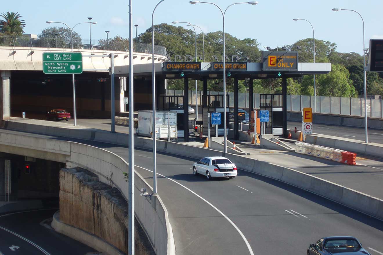 A bridge over a highway and toll collection point on the road