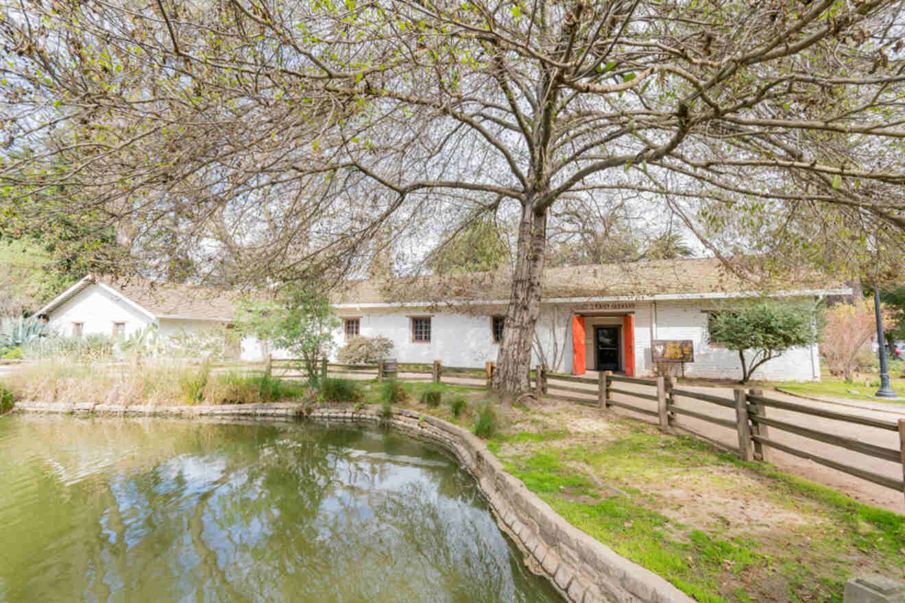 A house with a pond in front of it.