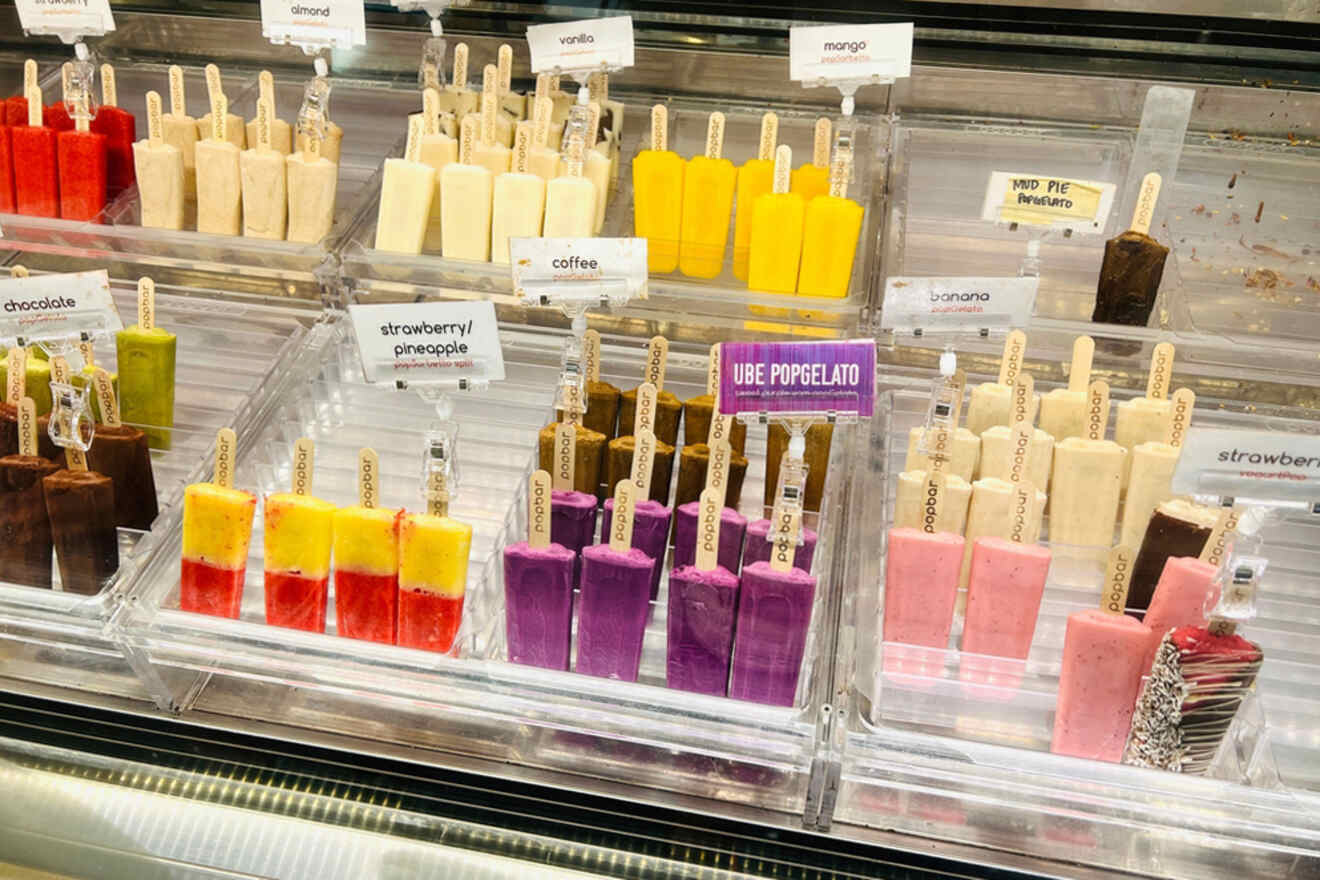 A display of ice cream pops in a glass case.