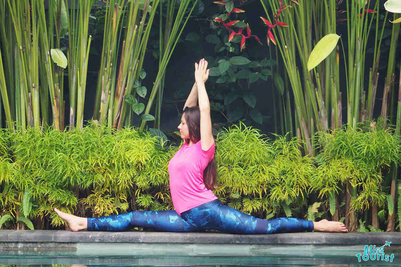A woman doing yoga in front of a pool.
