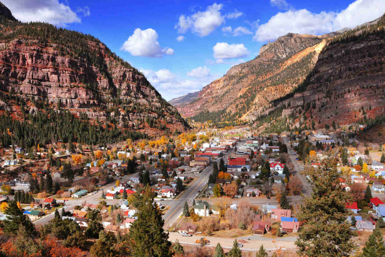 A town in colorado with mountains in the background.