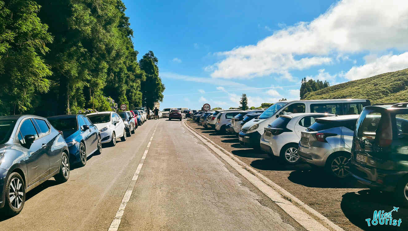 A line of cars parked on the side of a road.