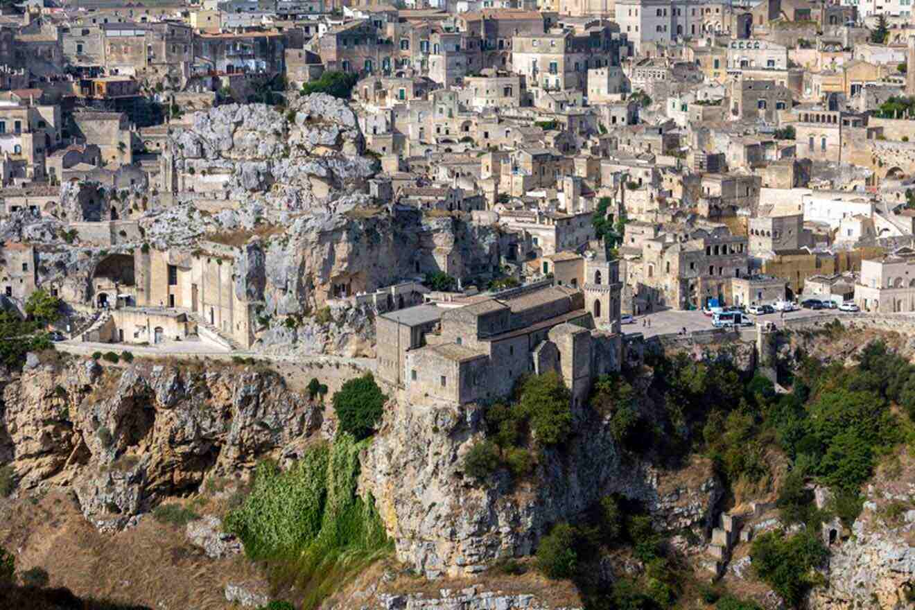 a city on a cliff with a lot of buildings on top of it