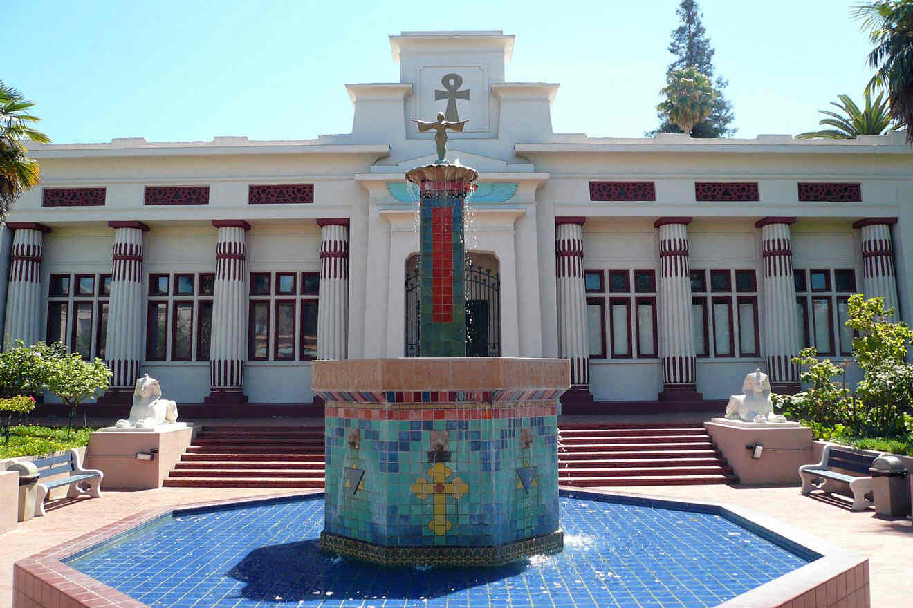 A fountain in front of a white building.