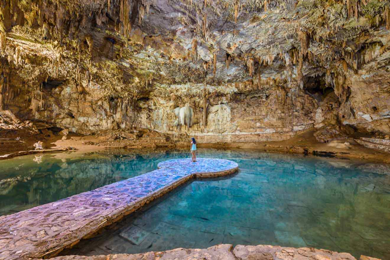 A person standing in an underground cenote