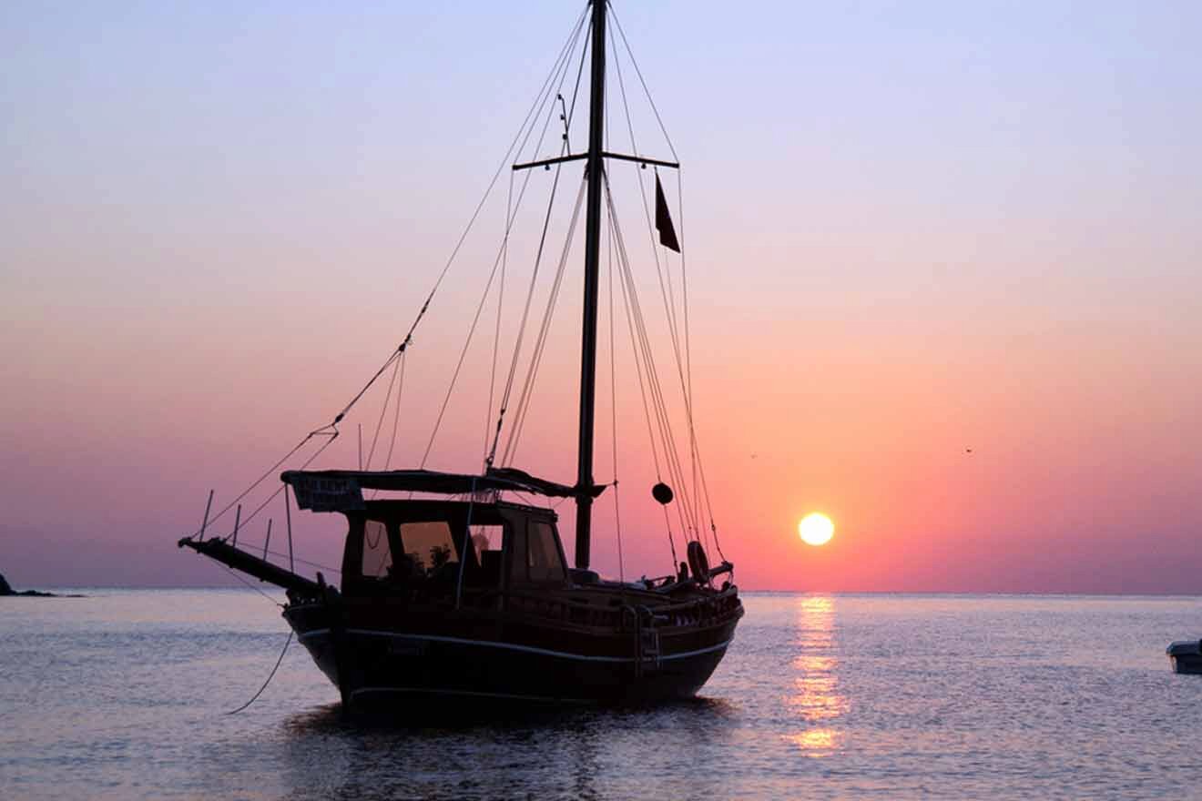 A sailboat in the water at sunset.