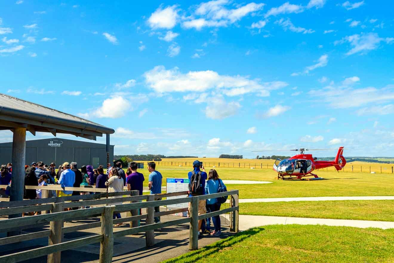 a group of people standing in front of a helicopter