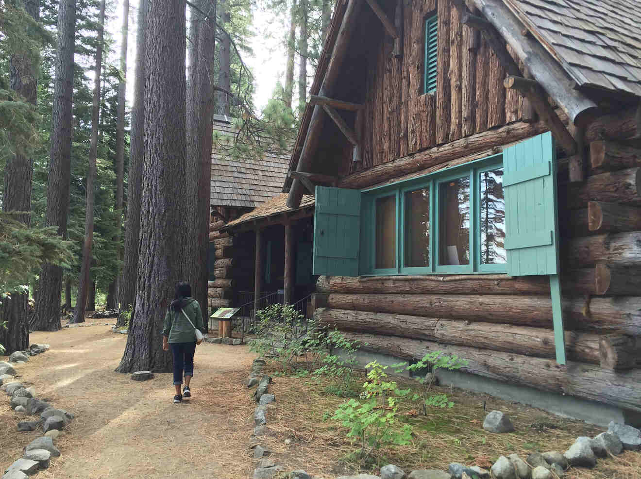 a person walking next to old wooden lodges