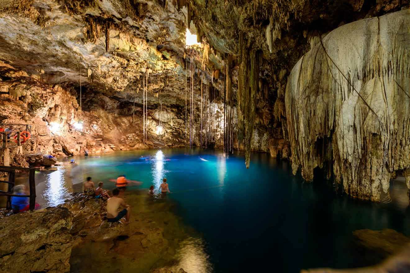 people swimming in an underground cenote
