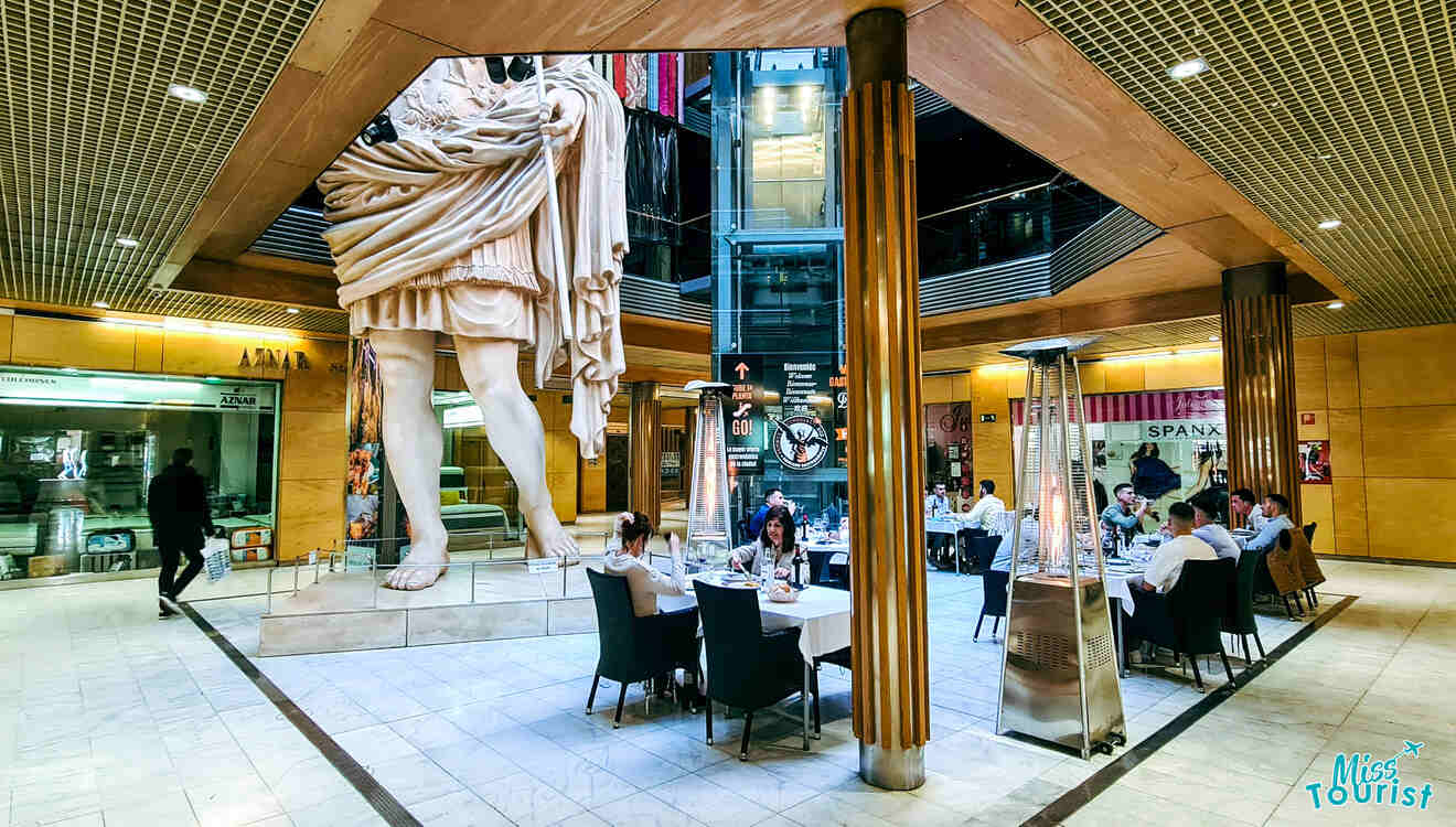 A restaurant with a large statue in the middle of it.