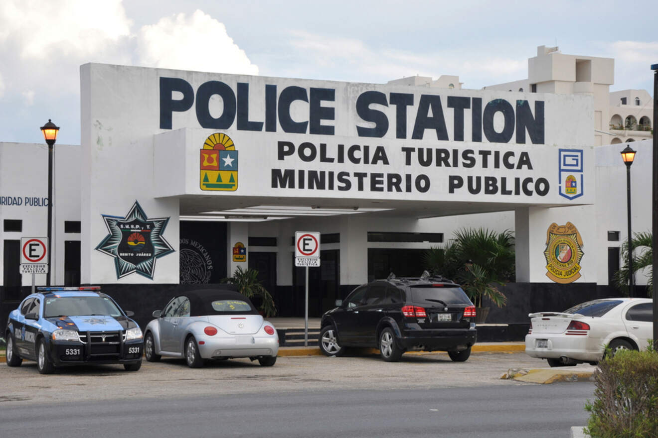 A police station with cars parked in front of it.