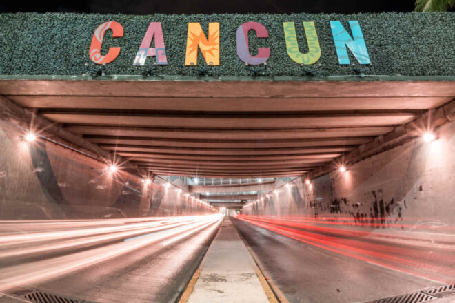 A tunnel with a sign that says cancun.