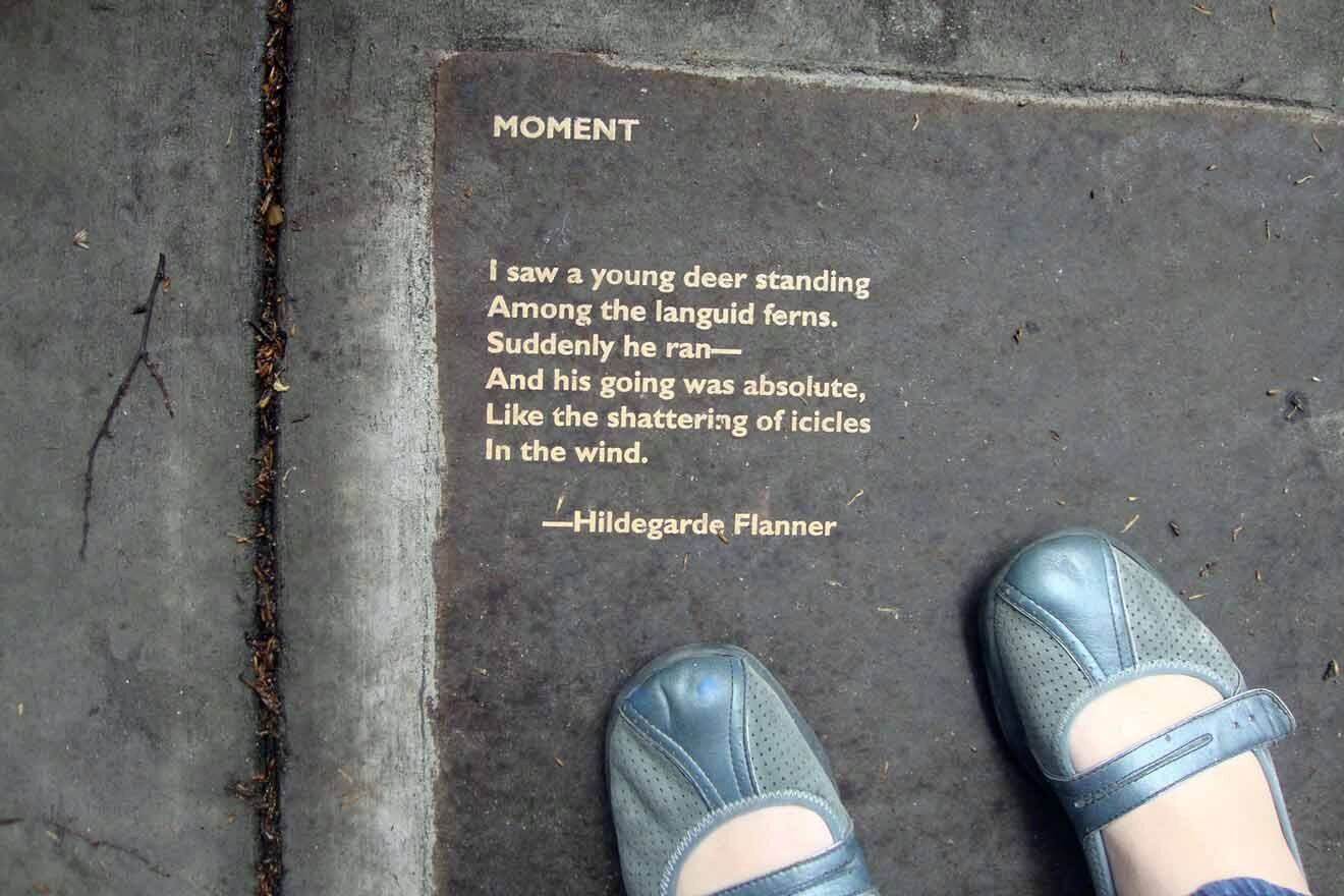 A person walking on a sidewalk with a poem written on it.
