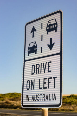 A sign that says drive on left in australia.