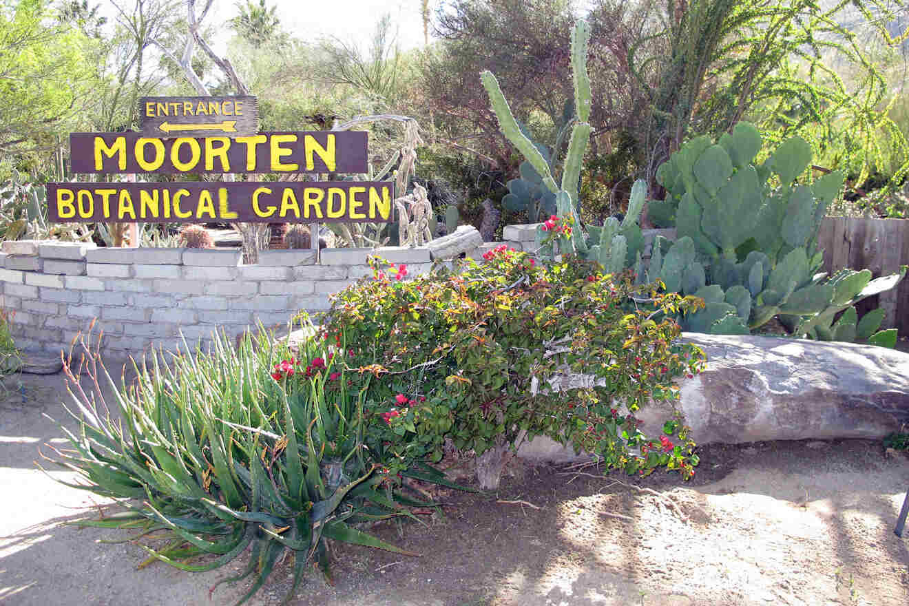 A sign for morten botanical garden in front of a cactus and other plants