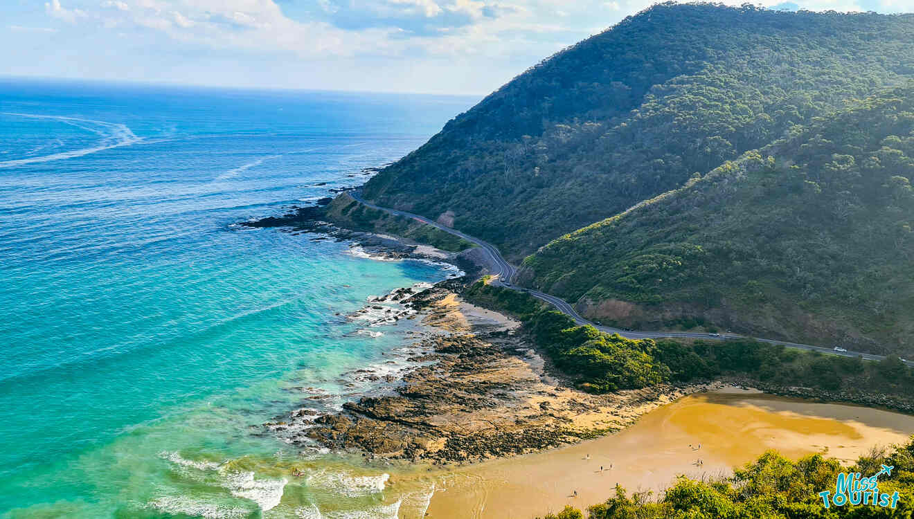 A scenic view of a beach and ocean from the top of a hill