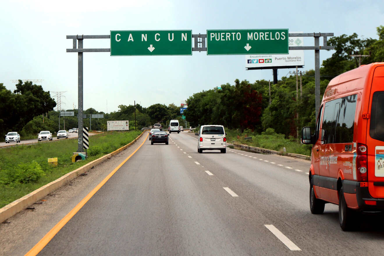 A van driving down a highway with a sign for cancun.