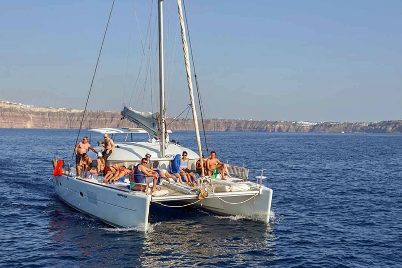 A group of people on a catamaran in the ocean.