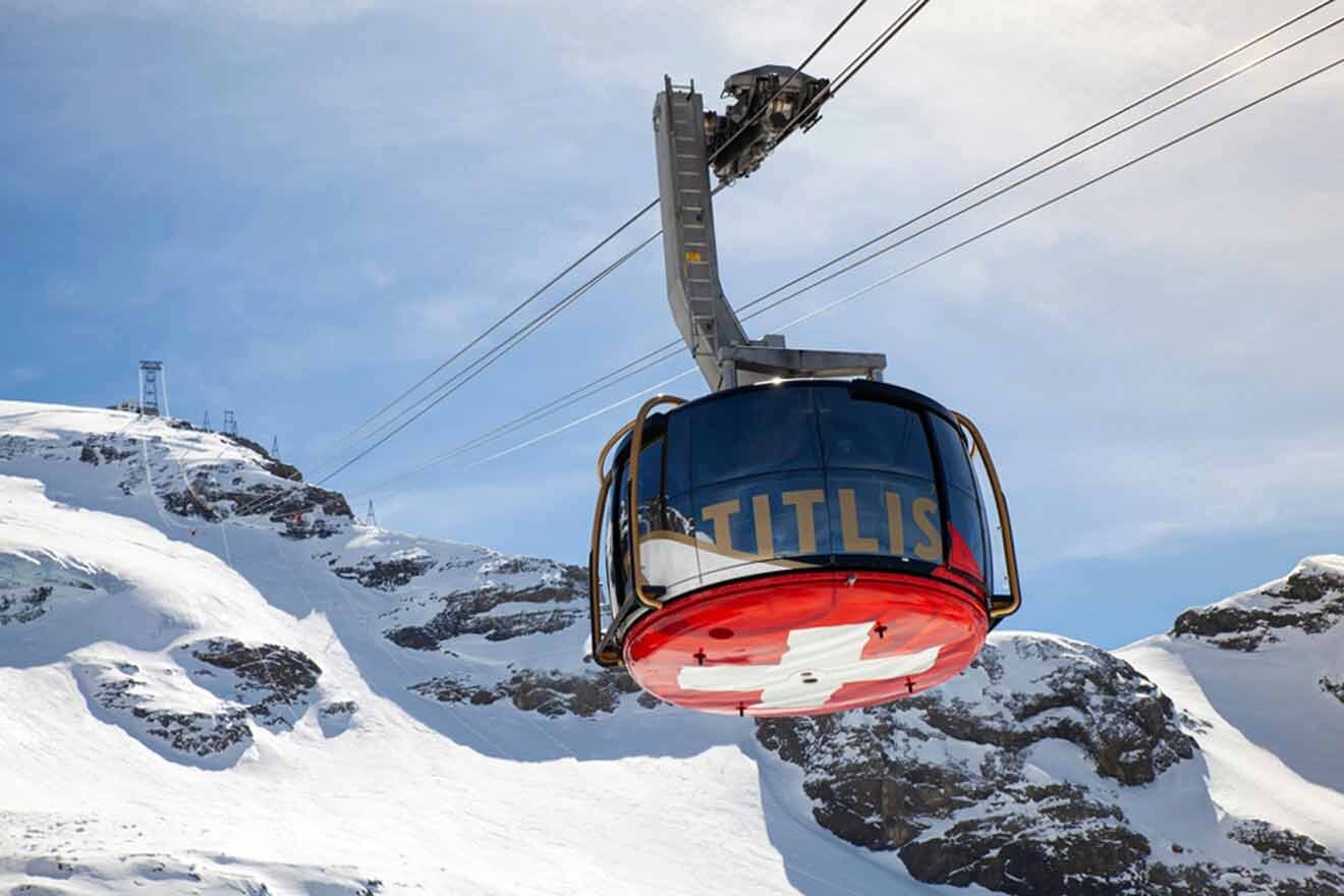 A gondola is flying over a snow covered mountain.