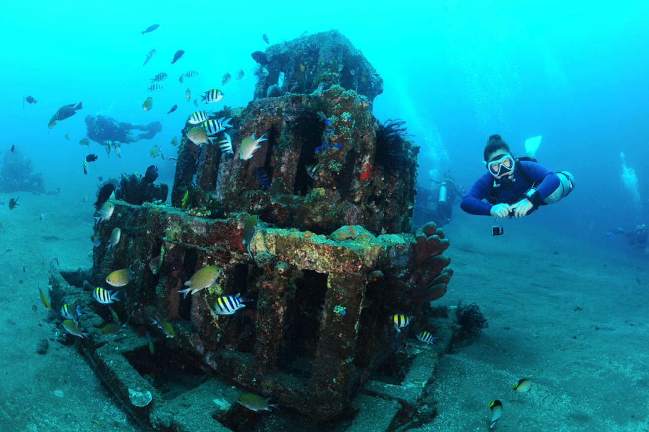A scuba diver in front of a wreck.